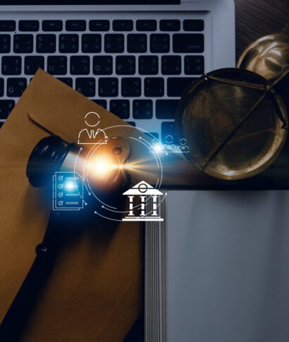 Justice and law concept.Male judge in a courtroom with the gavel, working with, computer and docking keyboard, eyeglasses, on table in morning light