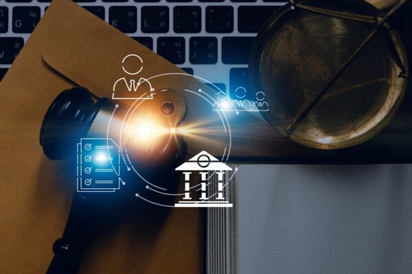 Justice and law concept.Male judge in a courtroom with the gavel, working with, computer and docking keyboard, eyeglasses, on table in morning light
